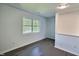 Bedroom featuring neutral walls, new flooring and natural light from large windows at 114 N Guthrie Ave, Durham, NC 27703