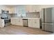 Modern kitchen featuring stainless steel appliances, gray backsplash and white cabinets and hardware at 114 N Guthrie Ave, Durham, NC 27703