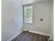 Clean laundry room featuring hardwood floors and a window for light at 114 N Guthrie Ave, Durham, NC 27703