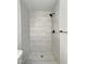 Modern shower featuring marble tile, new fixtures, with a glass door at 114 N Guthrie Ave, Durham, NC 27703