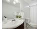 Bathroom featuring a modern sink, a dark vanity, and a toilet providing a functional space at 1208 Manassas Ct # A, Raleigh, NC 27609