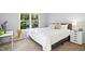 Bedroom with bright window, a plush bed, and a sleek side table offering a cozy retreat at 1208 Manassas Ct # A, Raleigh, NC 27609