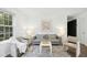 Bright living room featuring hardwood floors, a large window, a comfy couch, and stylish decor at 1208 Manassas Ct # A, Raleigh, NC 27609