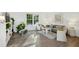 Bright living room featuring hardwood floors, a large window, a comfy couch, and stylish decor at 1208 Manassas Ct # A, Raleigh, NC 27609