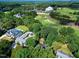 Aerial view showcasing the golf course, mature trees, and surrounding neighborhood with large residential homes at 1217 Briar Patch Ln, Raleigh, NC 27615