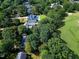 Aerial view showing home situated near the golf course, featuring mature trees, and lush landscaping at 1217 Briar Patch Ln, Raleigh, NC 27615