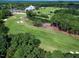 Scenic aerial view of the golf course featuring lush greenery, manicured fairways, and the country club at 1217 Briar Patch Ln, Raleigh, NC 27615