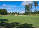 Clear view of the golf course, showcasing the lush fairways, sand traps, and clubhouse under a bright sky at 1217 Briar Patch Ln, Raleigh, NC 27615