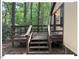 Exterior view of back deck with stairs leading to wooded lot at 125 Forsyth Dr, Chapel Hill, NC 27517
