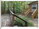 Cabin with back deck and stairs surrounded by lush green trees and greenery at 125 Forsyth Dr, Chapel Hill, NC 27517