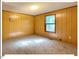 Cozy bedroom with carpeting, wood paneling and natural light at 125 Forsyth Dr, Chapel Hill, NC 27517