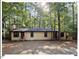 Cozy single-story home with a welcoming front porch nestled among the trees at 125 Forsyth Dr, Chapel Hill, NC 27517
