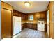 Well-lit kitchen offering wooden cabinets, a full sized refrigerator and modern countertops at 125 Forsyth Dr, Chapel Hill, NC 27517