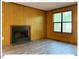 Living room with a brick fireplace and ample natural light from a large window at 125 Forsyth Dr, Chapel Hill, NC 27517