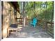 Side deck with table, adirondack chair surrounded by lush green trees and greenery at 125 Forsyth Dr, Chapel Hill, NC 27517