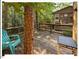 Side deck with table, adirondack chair surrounded by lush green trees and greenery at 125 Forsyth Dr, Chapel Hill, NC 27517