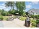 Landscaped backyard features a fire pit with seating, mature trees and a spacious patio for entertaining at 12500 Richmond Run Dr, Raleigh, NC 27614