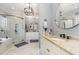 Elegant bathroom featuring marble tile, granite countertops and double vanity sinks at 12500 Richmond Run Dr, Raleigh, NC 27614