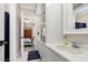Bright bathroom features a vanity with built in storage and a doorway view to the main bedroom at 12500 Richmond Run Dr, Raleigh, NC 27614