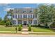 Charming two-story home with black shutters, covered porch, swing and manicured lawn at 12500 Richmond Run Dr, Raleigh, NC 27614