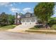 Charming home featuring a three-car garage, well-manicured lawn, and inviting curb appeal at 12500 Richmond Run Dr, Raleigh, NC 27614