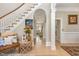 Grand foyer showcasing staircase, hardwood floors, arched hallway, and stylish design at 12500 Richmond Run Dr, Raleigh, NC 27614