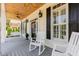 Inviting front porch featuring rocking chairs, swing, black accents, and a cozy ambiance at 12500 Richmond Run Dr, Raleigh, NC 27614