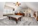 Attic game room features pool table, wet bar, and custom seating area at 12500 Richmond Run Dr, Raleigh, NC 27614