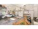 Bright garage with three bays, featuring a white Corvette and a golf cart at 12500 Richmond Run Dr, Raleigh, NC 27614