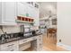 Custom kitchen features gray cabinets, black countertops, desk space and stainless steel appliances at 12500 Richmond Run Dr, Raleigh, NC 27614
