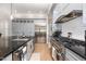 Modern kitchen featuring stainless steel appliances, granite countertops, and white cabinetry at 12500 Richmond Run Dr, Raleigh, NC 27614