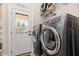 Well-lit laundry room with washer, dryer, and convenient access to the outside at 12500 Richmond Run Dr, Raleigh, NC 27614