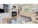 Cozy living room with fireplace, built-in shelves, hardwood floors, and comfortable seating at 12500 Richmond Run Dr, Raleigh, NC 27614