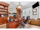 Spacious home office features custom built-ins, wood accents, and natural light from shuttered window at 12500 Richmond Run Dr, Raleigh, NC 27614