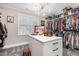 Organized walk-in closet with custom shelving, island and decorative lighting at 12500 Richmond Run Dr, Raleigh, NC 27614