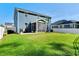 Expansive backyard featuring lush green grass and a covered screened-in porch at 128 Potomac River St, Garner, NC 27529