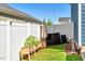 Backyard area featuring a white vinyl fence, patio furniture, an umbrella and plant containers at 128 Potomac River St, Garner, NC 27529