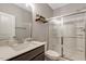 Modern bathroom features a walk-in shower with glass doors and floating shelves above the toilet at 128 Potomac River St, Garner, NC 27529