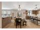 Open dining and kitchen area with hard floors, table, and stainless steel appliances at 128 Potomac River St, Garner, NC 27529