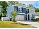 Attractive two-story house with an attached garage, well-kept lawn, and a young tree in the front yard at 128 Potomac River St, Garner, NC 27529