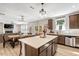 Kitchen showcases an island with seating, stainless steel appliances, and an open floor plan at 128 Potomac River St, Garner, NC 27529