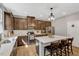 Open kitchen with stainless appliances, central island with bar seating and stylish pendant lighting at 128 Potomac River St, Garner, NC 27529
