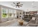 Spacious living room with large windows, and modern decor that flows into the kitchen at 128 Potomac River St, Garner, NC 27529