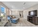 Spacious living area with a comfortable sofa and large TV, ideal for relaxation and entertainment at 128 Potomac River St, Garner, NC 27529