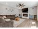 Spacious living room featuring a fireplace, TV, and plush sofa at 128 Potomac River St, Garner, NC 27529