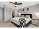 Comfortable main bedroom with a ceiling fan, ensuite closet, and bedside tables at 128 Potomac River St, Garner, NC 27529