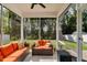 Comfortable screened porch with neutral outdoor furniture, pillows, and a view of the backyard at 128 Potomac River St, Garner, NC 27529