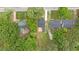 Aerial view showing a nice backyard with deck, green grass, and treed surroundings at 128 W Parker St, Henderson, NC 27536