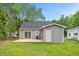 A serene backyard featuring a new deck, sliding glass door, and a charming exterior door at 128 W Parker St, Henderson, NC 27536