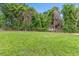 Expansive backyard offering a lot of space, with ample greenery and surrounding trees at 128 W Parker St, Henderson, NC 27536